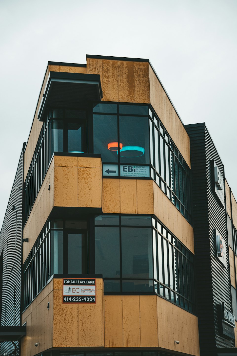 Modern office building with golden panels and large windows.