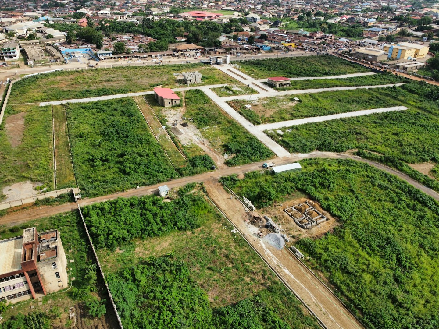 Aerial view of a developing construction site with roads and building foundations.
